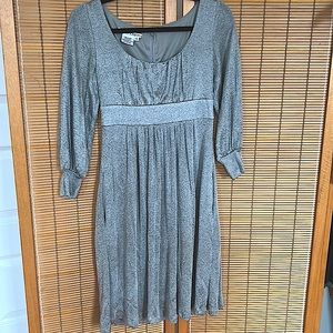 Long sleeve fit flare silver cocktail dress with beautiful low scoop neckline.